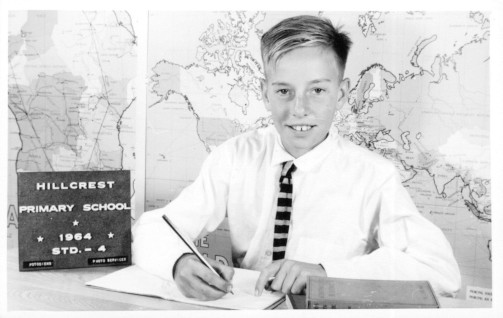 Michael E. Holdsworth, author and writer, as a young boy with pen and paper in hand.