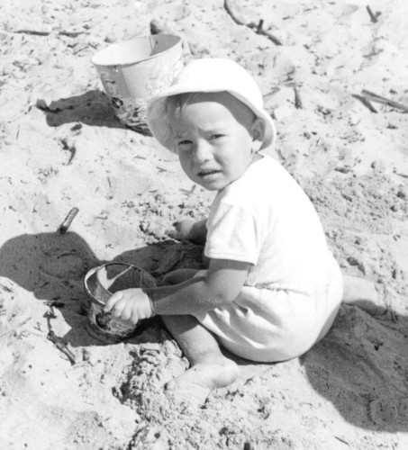 Michael E. Holdsworth, author, writer and storyteller, on beach as a toddler - 1956